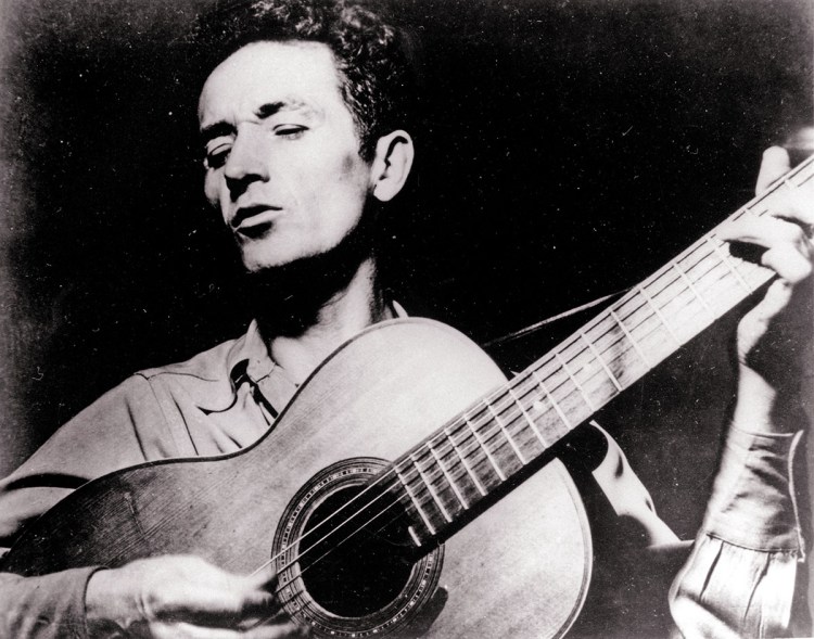Folk singer Woody Guthrie wrote hundreds of songs, celebrating migrant workers, pacifists, and underdogs.  Undated photo by the Associated Press