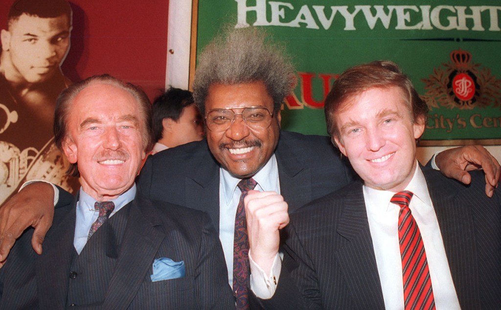 Donald Trump, right, pictured with his father, Fred Trump, far left, and boxing promoter Don King at a press conference in December 1987 in Atlantic City, N.J.  The Associated Press