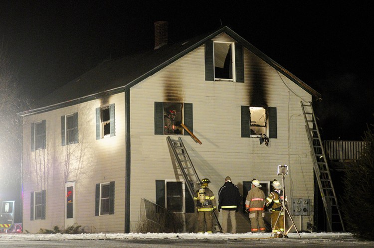 Firefighters battle a house fire on Town Farm Road in Hallowell on Thursday night.