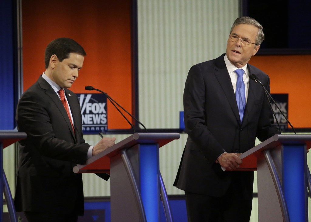 Jeb Bush, right, talks as Marco Rubio listens during Thursday's debate. He said sarcastically, "I kind of miss Donald Trump, he was a teddy bear to me."
The Associated Press