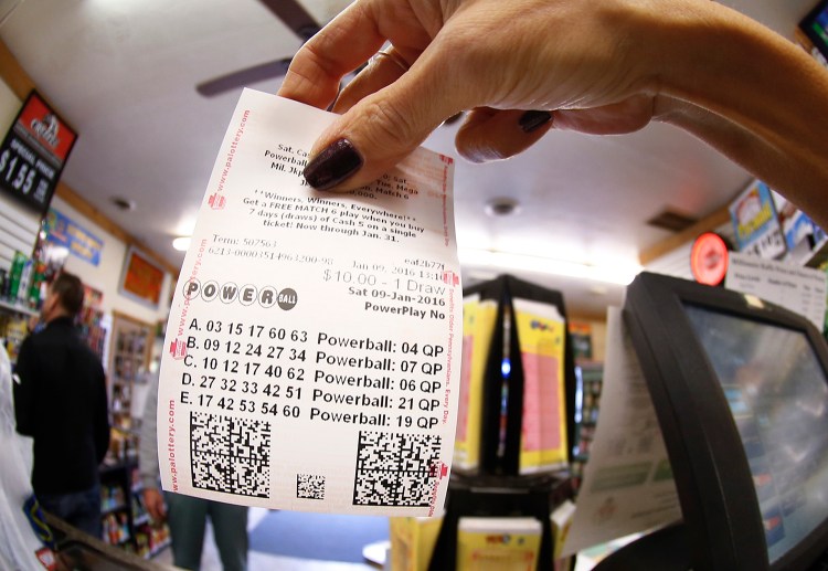 In this photo made with a fisheye lens a clerk hands a patron his $10 worth of chances for the upcoming Powerball drawing on Saturday. The Associated Press