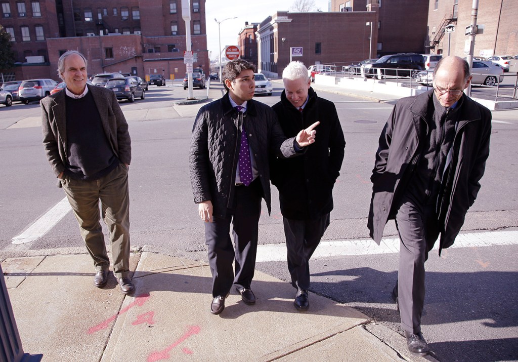 Fall River Mayor Jasiel Correia walks with a group of architechs in Fall River, Mass. The Associated Press