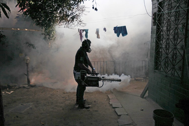 A health worker fumigates the Altos del Cerro neighborhood as part of preventive measures against the Zika virus and other mosquito-borne diseases in Soyapango, El Salvador, on Thursday. Reuters