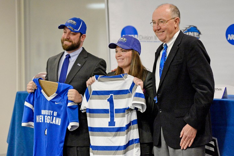 UNE Athletic Director Jack McDonald, right, introduces new football coach Mike Lichten and new women's rugby coach Ashley Potvin at the University of New England Thursday. Shawn Patrick Ouellette/Staff Photographer