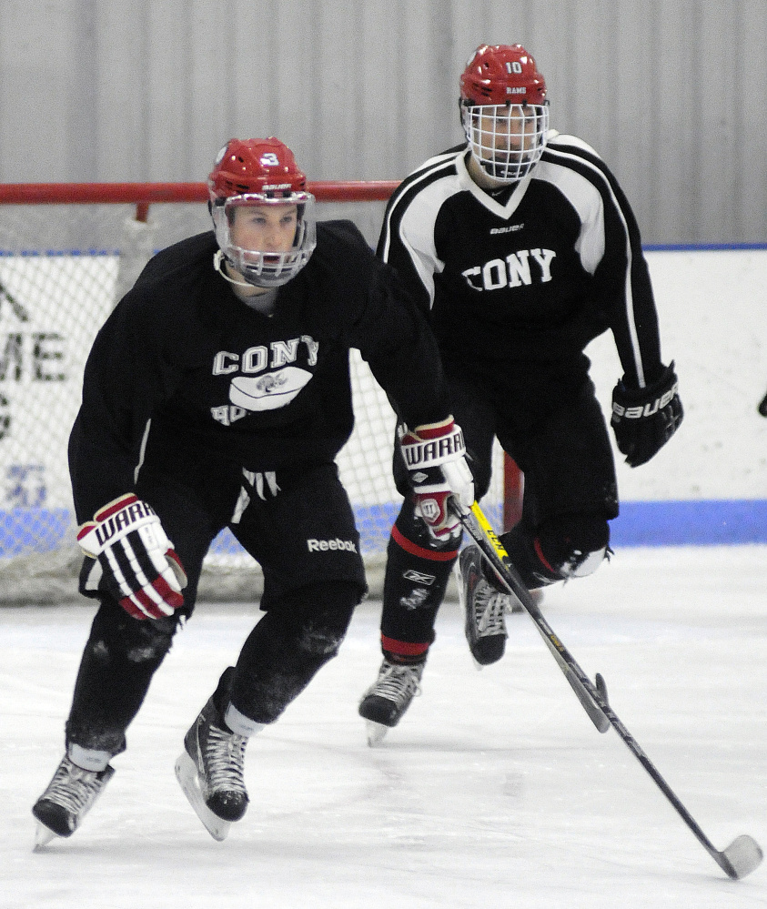 Cony High School hockey players Riley Boivin, right, and Connor Perry skate during practice Monday at the Ice Vault in Hallowell.