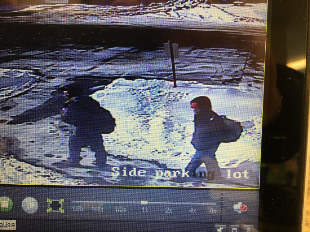 A surveillance image shows suspects who stole money from the Isaac F. Umberhine Library in Richmond.