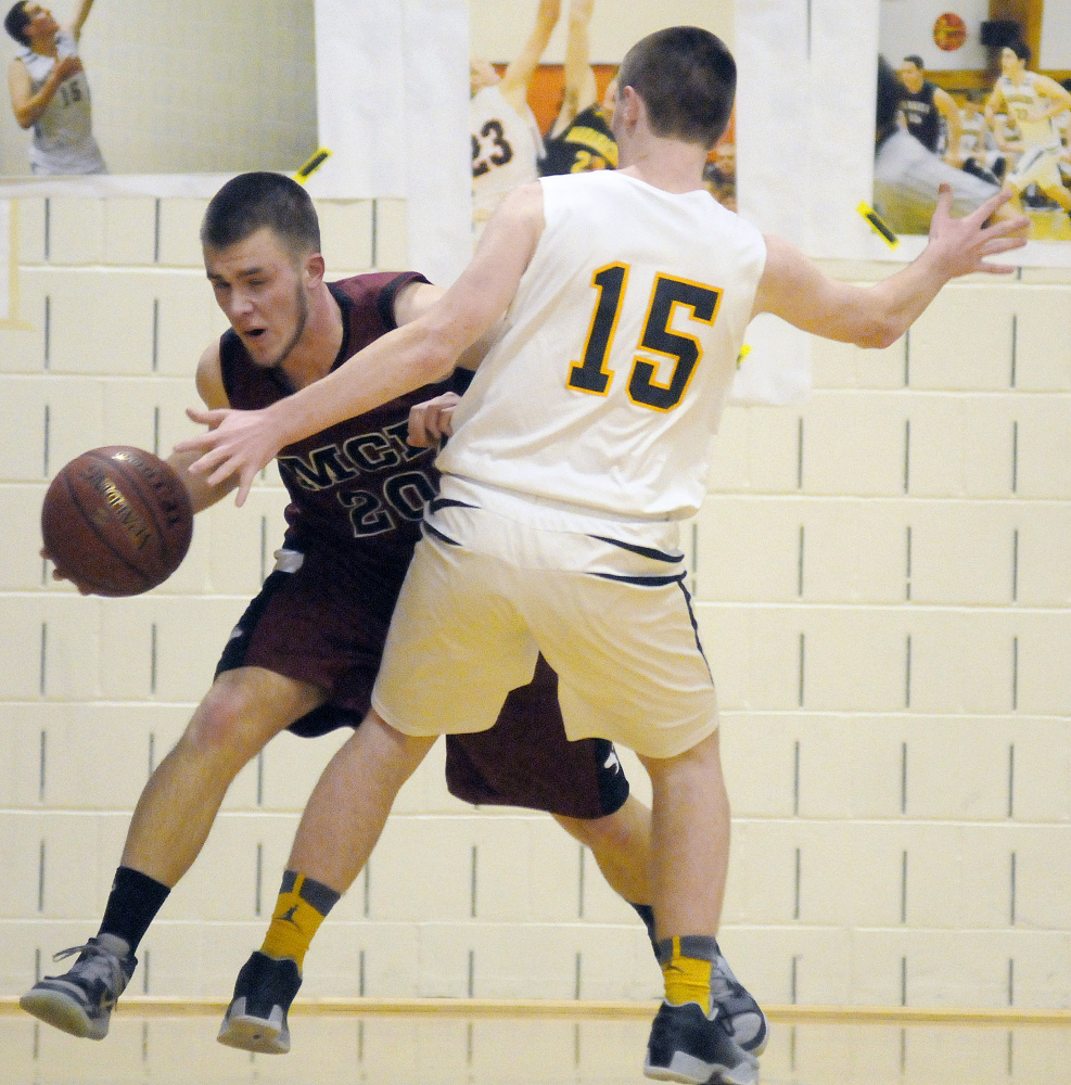 Maranacook’s Jason Brooks (15) blocks Maine Central Institute’s Carter Pearl during a game Tuesday in Readfield.