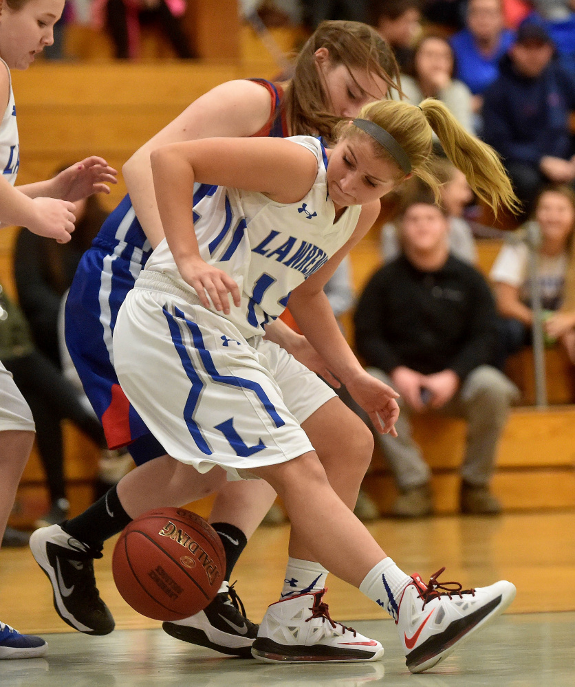 Lawrence senior guard Dominique Lewis looks for the ball as Messalonskee’s Cassidy Baker defends during a Kennebec Valley Athletic Conference Class A game earlier this season in Fairfield. Lewis scored her 1,000th career point Tuesday night in Brewer. The team will honor her Thursday night.