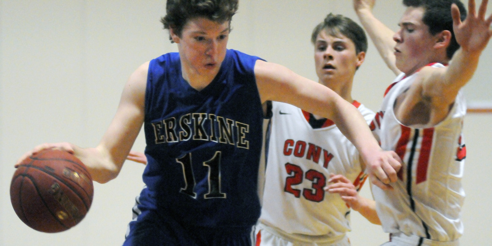 Cony's Keith Briggs, right, gets pushed aside as Erskine's Caleb Barden dribbles past him and Carter Cleaves during a game Thursday in Augusta.
