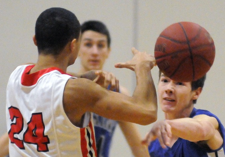 Cony's Jordan Roddy, left, gets a shot blocked by Erskine's Trevor Hubbard during a game Thursday  in Augusta.