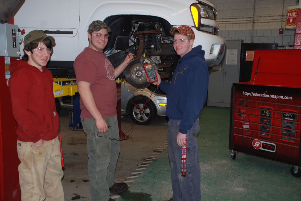 From left, Gregory Shrader, of Canaan; Owen Boardman, of Cornville; and Aaron Noonan, of Pittsfield, are learning how to measure wheel speed sensor signals on the Chevrolet Trailblazer, one of three vehicles donated to Somerset Career and Technical Center in Skowhegan by General Motors Company and the GM Automotive Service Education Program at Lakes Region Community College in Laconia, N.H. The GM vehicle donation program supports automotive technical education at high school career and technical centers and community colleges throughout New England. Receiving programs must be accredited by the National Automotive Technical Education Foundation. Automotive instructor Mark Wilson, who recently received the three vehicles that students will hone their service and diagnostic skills, said, “These students are learning how to use the Snap On meter at the same time they are developing an understanding of the inputs used to make the GM anti-lock braking system work. The meter training the students receive prepares them to pass an examination which earns them Snap On Meter Certification. The use of these donation vehicles will provide our students the opportunity to learn about the systems they will be diagnosing and servicing in the workplace. We are very pleased to receive these vehicles and will make good use of them.”