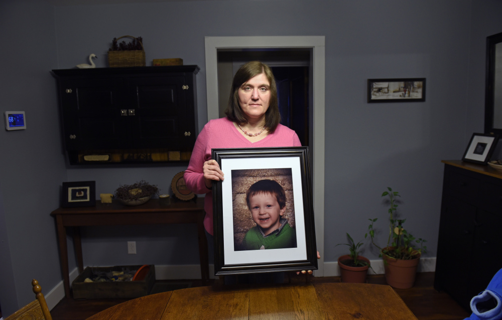 Hollie Ayers poses with a photograph of her late son, Michael, 2, at her home in Bedford, Pa., on Jan. 18. Michael, was shot and killed in front of her by her abusive ex-husband in 2013. Ayers was shot in the face and the leg, and her ex-husband killed himself after the rampage. More than a dozen states over the past two years have strengthened laws meant to keep firearms out of the hands of domestic abusers, a rare area of consensus in the nation’s highly polarized debate over guns.