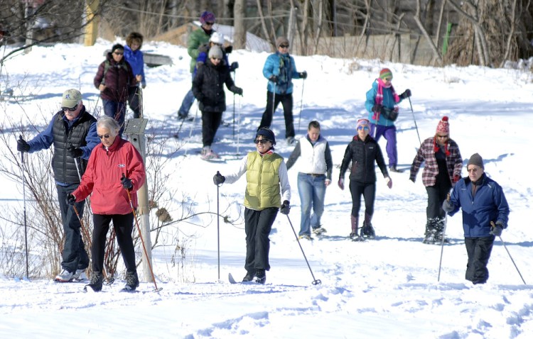 People ski and snowshoe Sunday across Viles Arboretum in Augusta during the Table Tour fundraiser.