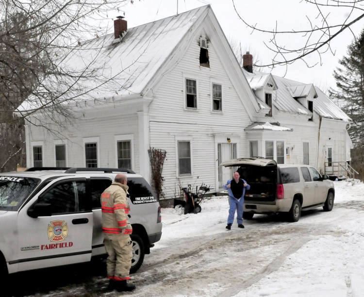 Fairfield Fire Chief Duane Bickford, left, and s fire marshal investigator Jeremy Damren prepare to enter a home on Middle Road in Fairfield on Monday after it was substantially damaged by a fire Sunday evening.