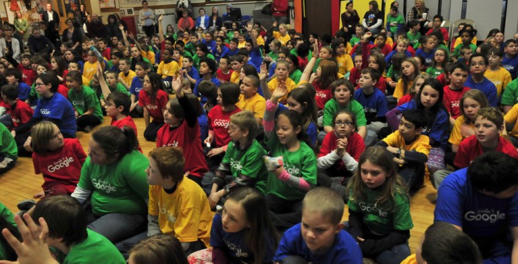 Albert S. Hall School students, during a school assembly Monday, wear Google T-shirts and ask questions of fifth-grade student Karin Zimba about her art project “Serendipity” that was selected as the Maine winner in the national Doodle 4 Google contest.