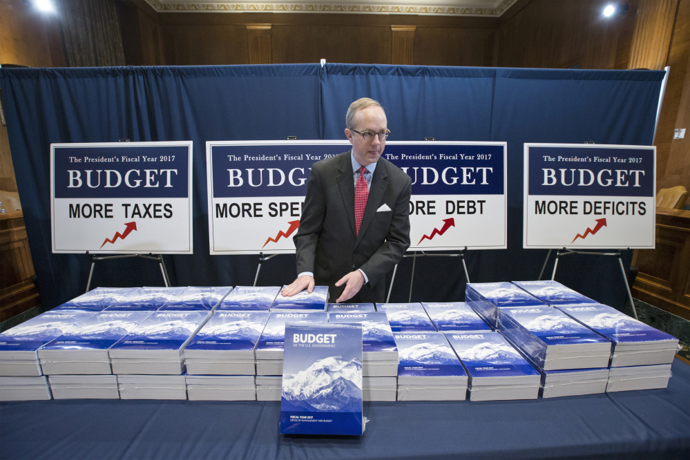 Copies of President Barack Obama’s final fiscal 2017 federal budget proposal are staged for display by Eric Euland, Republican staff director for the Senate Budget Committee, Tuesday on Capitol Hill in Washington.