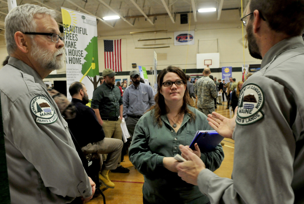 Staff photo by David Leaming
Unity College student Shannon Johnson listens to park managers Fritz Appleby, left, and Matt McQuire of the Maine Department of Agriculture, Conservation and Forestry about employment opportunities during a career fair at the college on Tuesday.