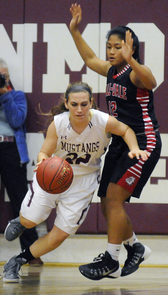 Monmouth’s Sidney Wilson dribbles around Hall-Dale’s Lilly Ly during a Class C South prelim game Tuesday in Monmouth.