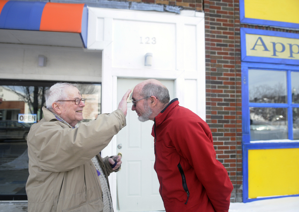 The Rev. James Gill applies ashes to Bill Nave on Main Street in Winthrop on Ash Wednesday.