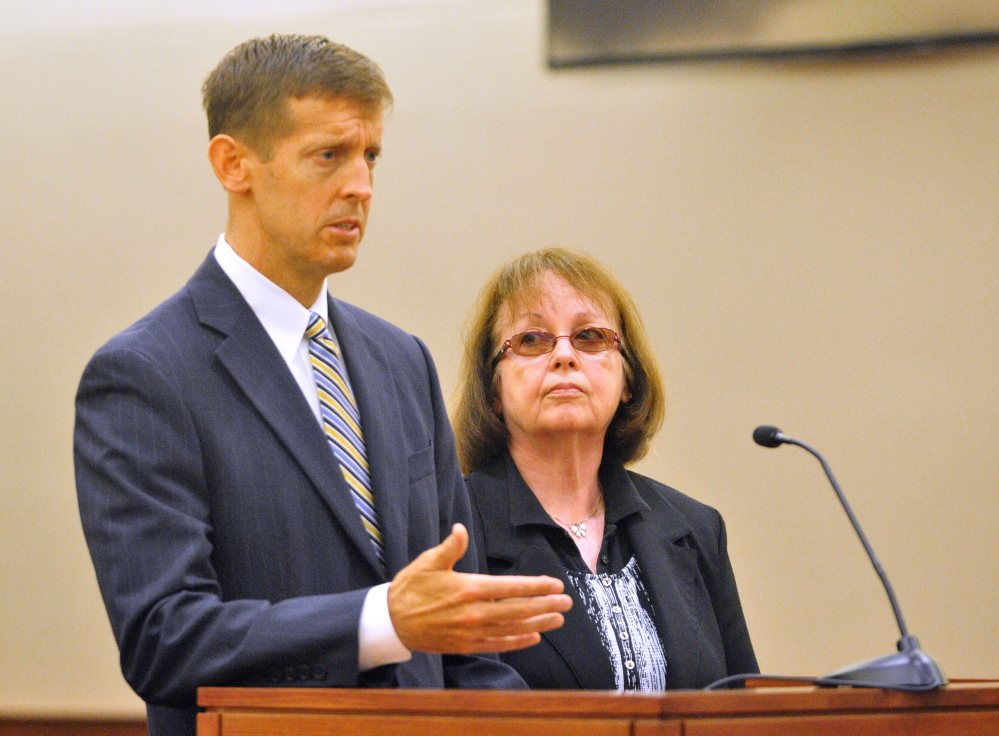 Claudia Viles stands with her attorney Walter McKee as she pleasds not guilty to 13 counts of fraud in September in Kennebec County criminal court in Augusta. She is charged with stealing more than $438,000 in town excise tax money while town clerk in Anson and is scheduled for a June trial.