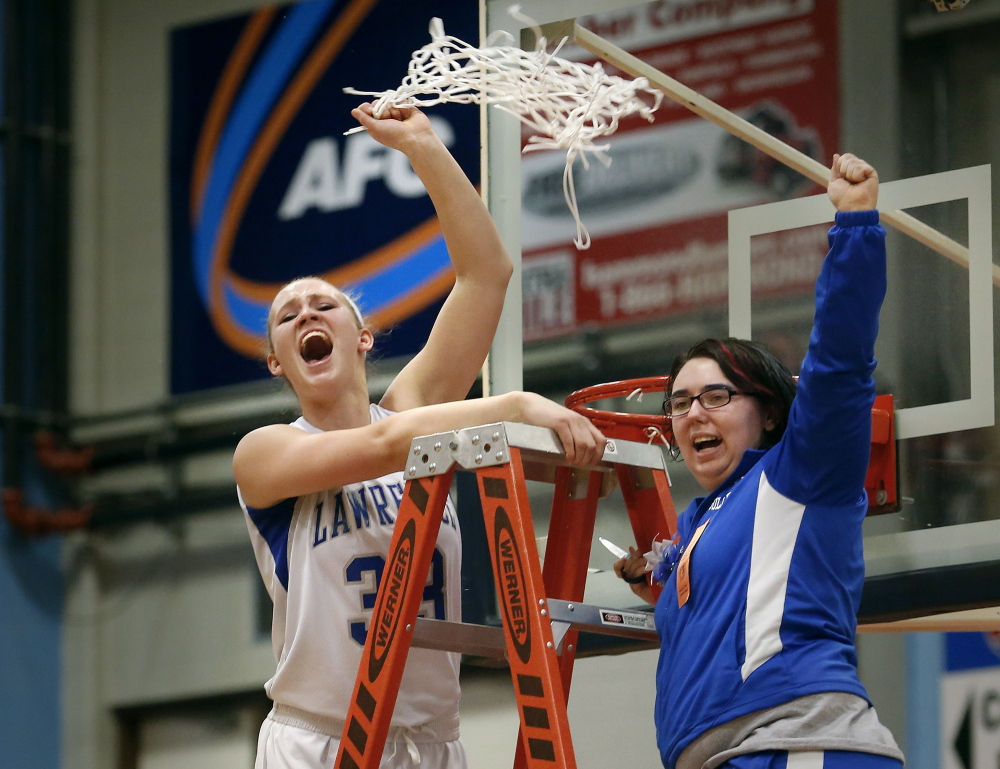 Lawrence forward Nia Irving, left, had some fun cutting down the nets after the Bulldogs sank Thornton Academy in the Class A state title game last season. Irving and the Bulldogs open their title defense Friday night against Skowhegan.