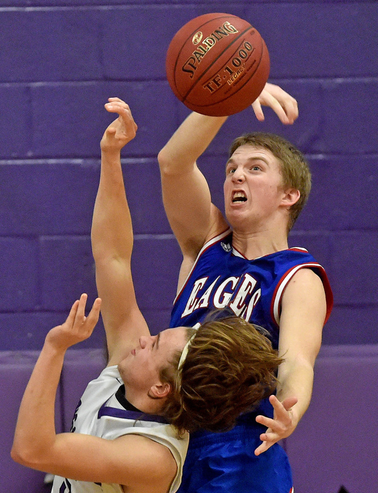 Messalonskee’s James Lathrop (22) rejects a shot by Waterville’s Gavin LaChance during a game in Waterville earlier this season. The No. 4 Eagles will play No. 5 Oceanside in a Class A North quarterfinal game Saturday at the Augusta Civic Center.