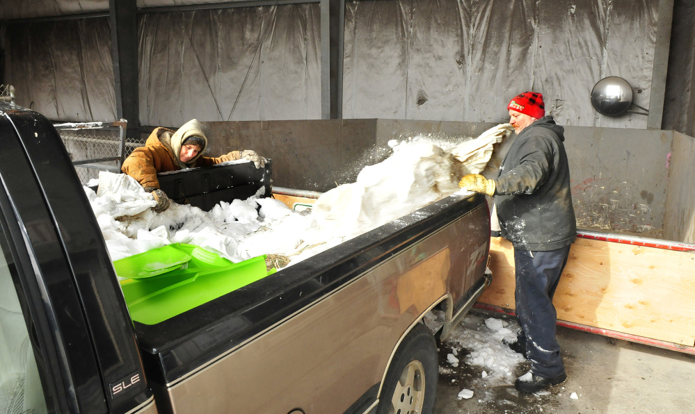 Jay residents Molly and Mark Turner toss trash from their truck into a waste collector Thursday at the Jay transfer station. The town is closing the transfer station to the other towns that use it — currently Carthage and Fayette — after June 30.