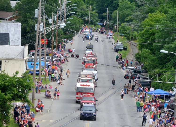 The annual Winslow Family 4th of July parade marches down Bay Street in Winslow last year. Organizers of the three-day celebration, which also includes bands and a fireworks show, say a higher bill from the Police Department might make it impossible to continue holding the event.