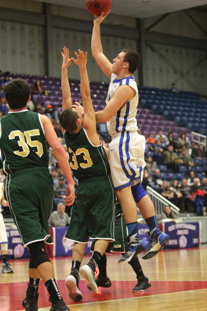 Valley’s Collin Miller puts up a shot over Rangeley’s Kyle LaRochelle during the first half of a Class D South quarterfinal Saturday at the Augusta Civic Center.