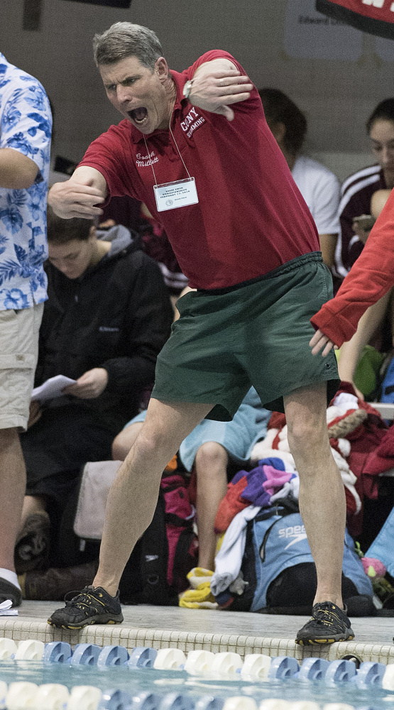 Cony swim coach John Millett urges his swimmers on during the Class A girls swim championships at Wallace Pool on the University of Maine campus Saturday in Orono.