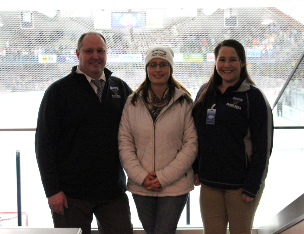 Holly Thebarge, center, of Smithfield, recently won a social media giveaway of University of Maine hockey tickets hosted by Sullivan Tire and Auto Service and UMaine. At the game, she meets with Jason Hoyt, Black Bear Sports Properties, left; and Jill Tuell, Black Bear Sports Properties.