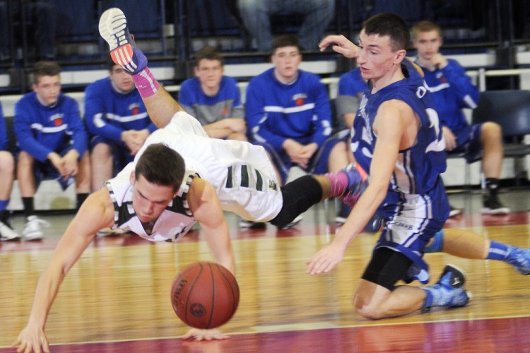 Winthrop High School’s Bennett Brooks, left, flies over Old Orchard Beach High School’s Zach Hirst on Monday in Augusta.