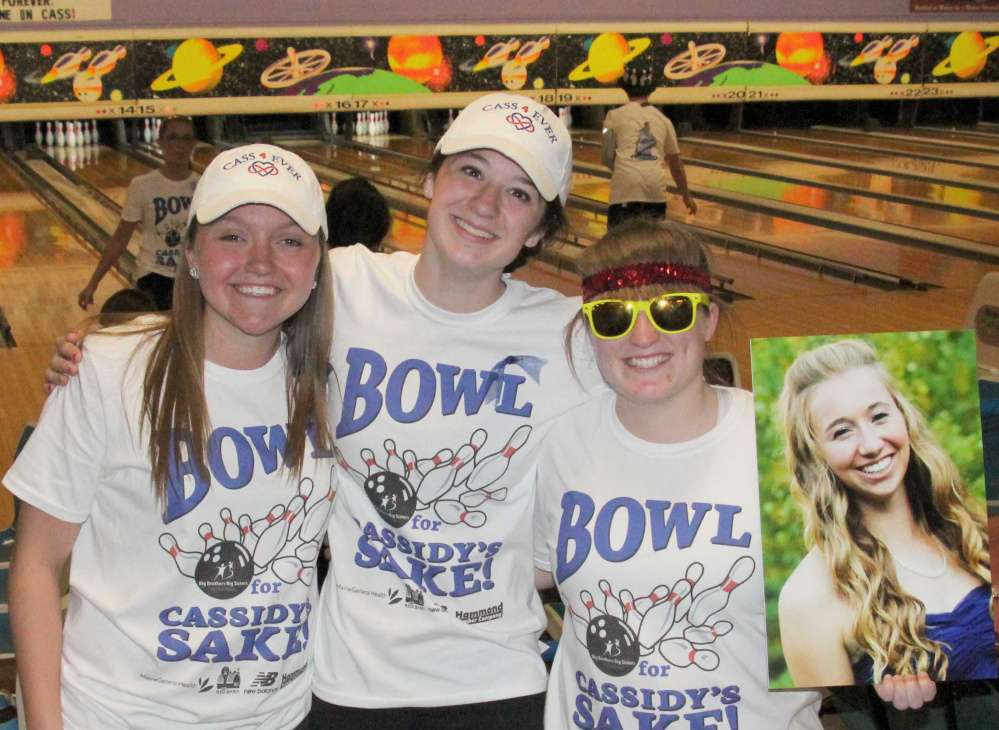 Jordyn Labrie, Paige Smith and Gabi Martin, members of the Central Maine United soccer team, hold a photo of their friend and former teammate Cassidy Charette at last year’s first “Bowl for Cassidy’s Sake” that raised $50,000 for the Messalonskee school-based mentoring program. This year’s event, on May 7th at Sparetime Recreation in Hallowell, will raise funds for a new program at the Alfond Youth Center in Waterville.