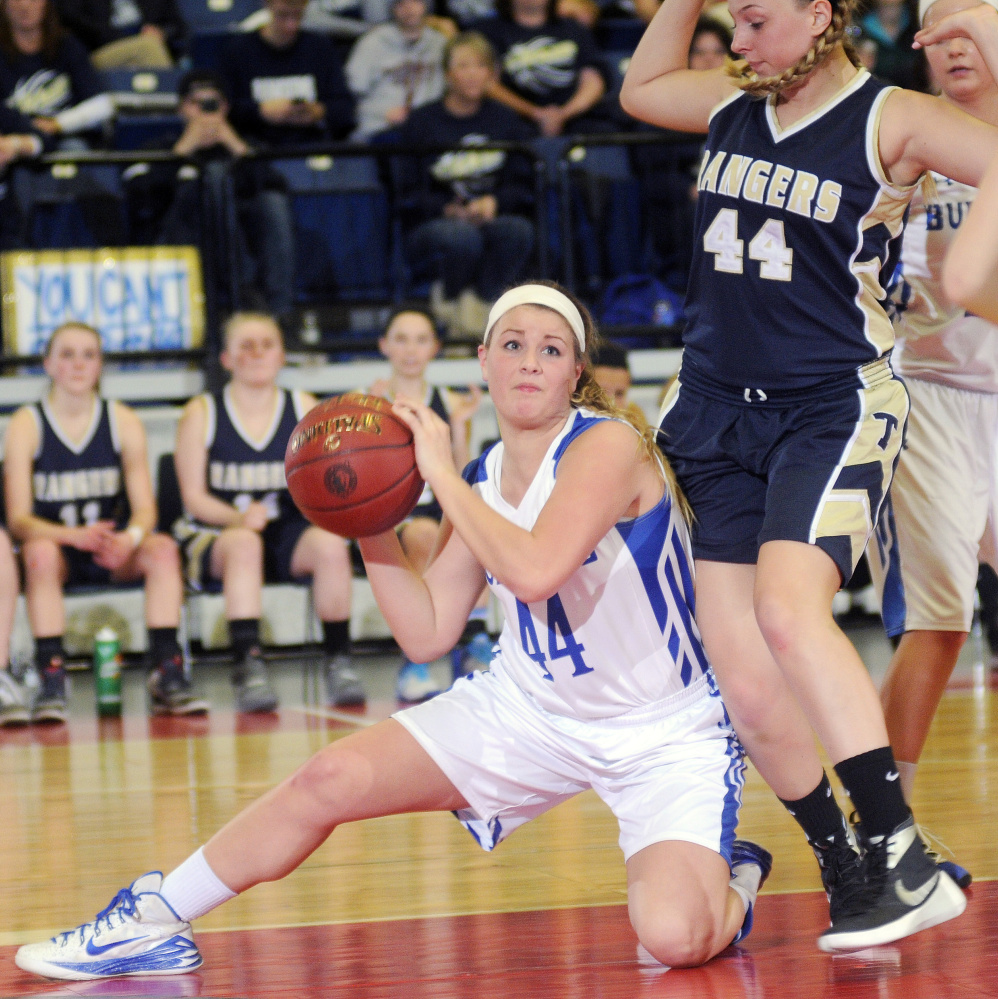 Madison’s Erin Whalen looks for an opening around Traip’s Marina Casey during a Class C South quarterfinal Tuesday at the Augusta Civic Center.