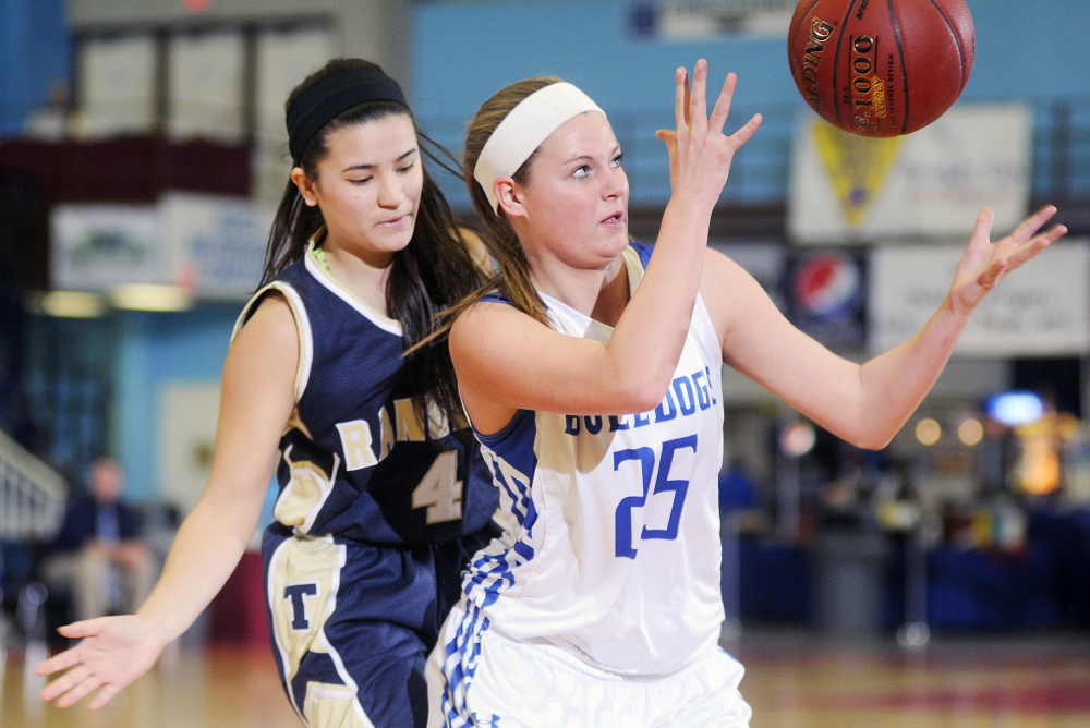 Madison’s Emily Oliver grabs a rebound in front of Traip’s Kiara Perez during a Class C South quarterfinal Tuesday at the Augusta Civic Center.