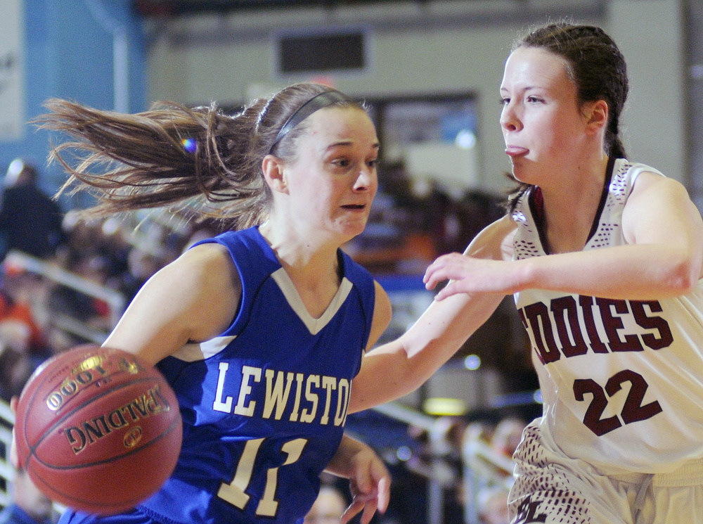 Lewiston’s Kristina Blais, left, dribbles around Edward Little’s Piper Norcross during a Class AA South girls semifinal Tuesday at the Augusta Civic Center. Norcross scored 13 points to help the Red Eddies cruise to a 58-23 victory.