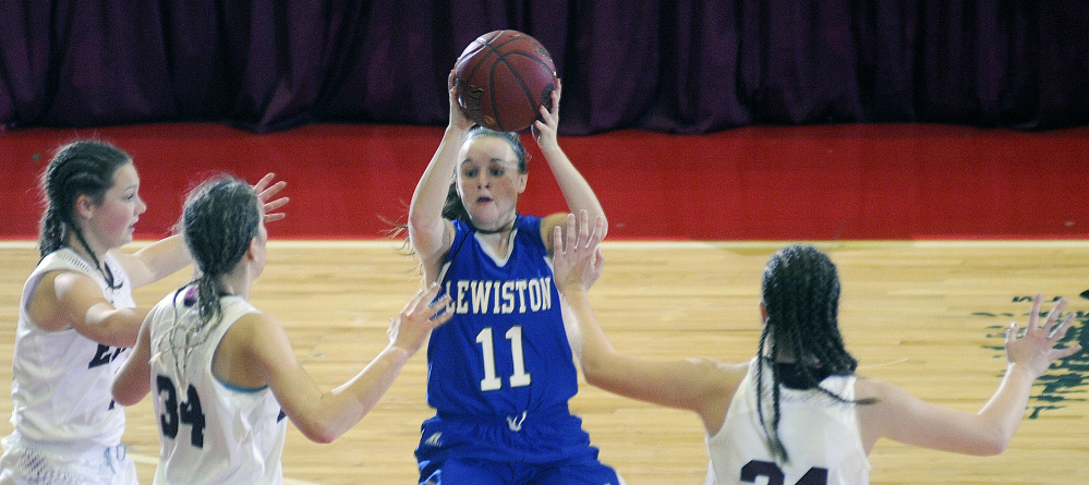 Lewiston’s Kristina Blais looks for an open teammate as a swarming Edward Little defense converges during an AA South girls semifinal game Tuesday at the Augusta Civic Center.
