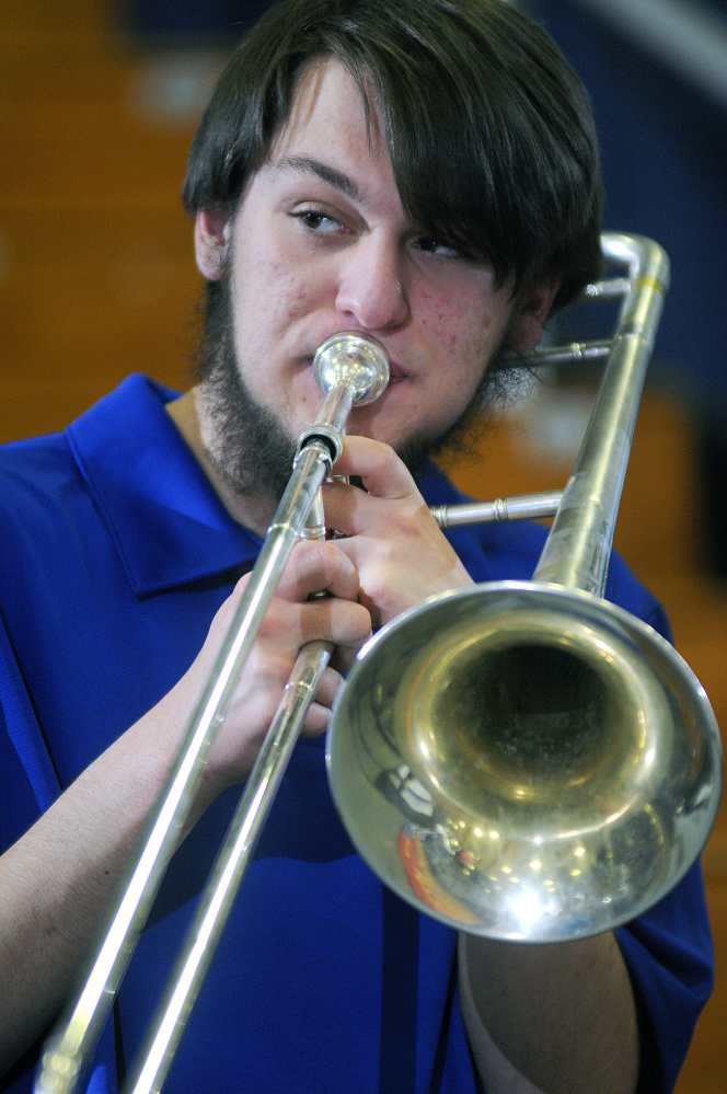 Madison’s Dominic Fazio plays the trombone during a Class C South quarterfinal game Tuesday against Traip Academy at the Augusta Civic Center.