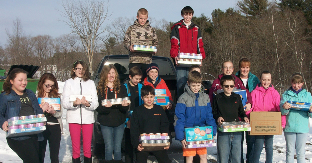 In front, from left, are Owen Schuchardt, Lucas Williams and Ryan Wahl. Second row, from left, are Bina Harriet, Jessica Lange, Danica Soule, Marissa Elwell, Connor Veilleux, Ethan Loubier, Lexxis Sirois, Anna Lakey, Irene Dineen (teacher and fundraiser coordinator), Megan Huessers and Kaitlin Morrison. On truck, from left, are Landen Gillis and Nick Weiss.