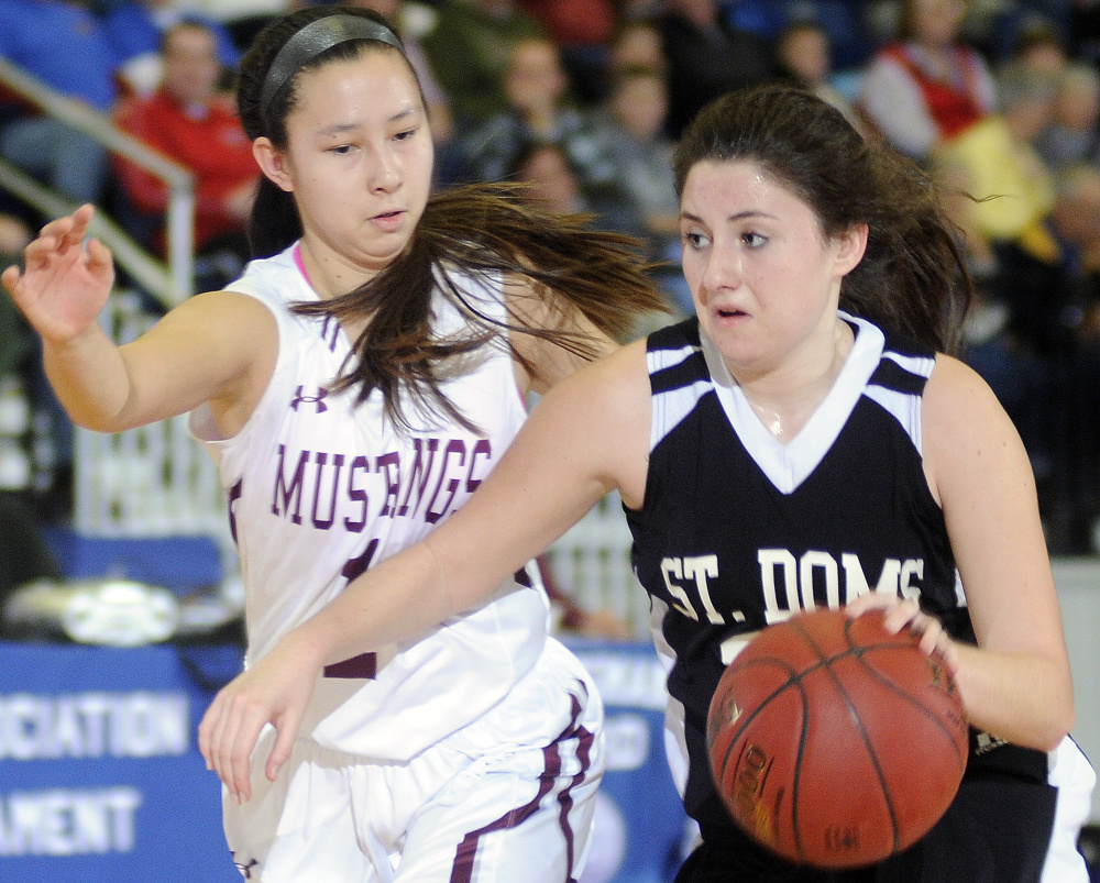 Monmouth Academy’s Tia Day guards St. Dominic Academy’s Allie Veinote during a Class C South quarterfinal game on Monday in Augusta.