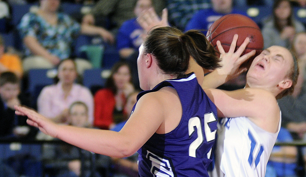 Lawrence’s Nia Irvng, right, grabs a rebound around Hampden’s Braylee Wildman during a Class A North semifinal Wednesday night at the Augusta Civic Center.