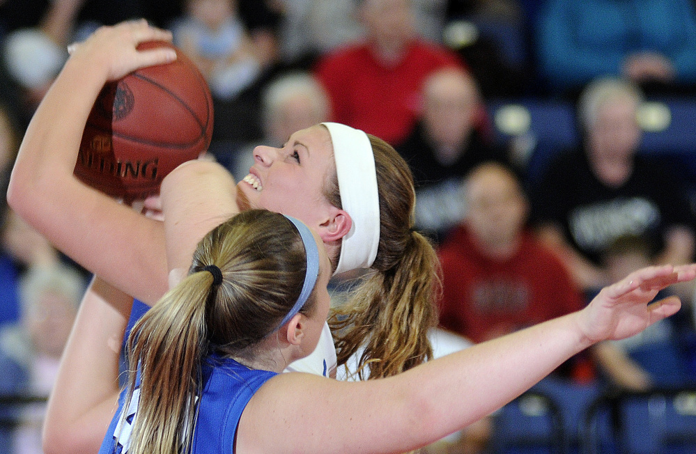 Madison Area Memorial High School’s Erin Whalen gets a shot while being a fouled by Searsport District High School’s Anna Bucklin during a Class C South semifinal game Thursday in Augusta.