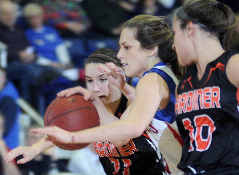 Gardiner’s Leslie Stevens, left, and Leah Weymouth squeeze Messalonskee’s Sophie Holmes, middle, during a Class A North girls semifinal Wednesday afternoon at the Augusta Civic Center.
