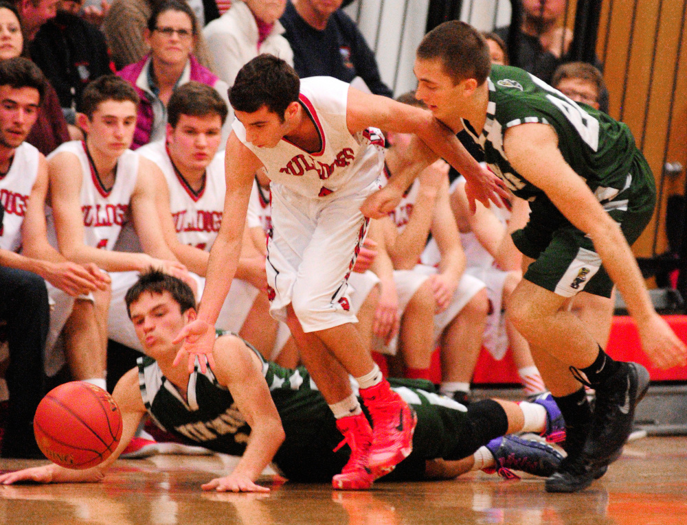 Winthrop juniors Bennett Brooks, left, and Andrew Pazdziorko, right, and Hall-Dale’s Tyler Nadeau scramble for a loose ball in a game earlier this season at Penny Memorial Gym in Farmingdale. The junior class has played a big part in the Ramblers’ run to the Class C South championship game.
