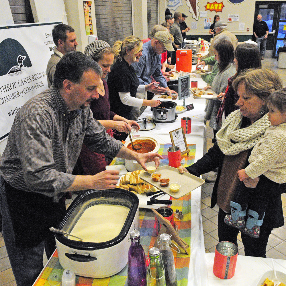 Patrons go through the line during the chili, chowder and soup fundraiser event on Saturday at Winthrop High School.