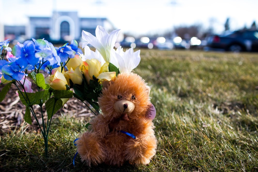 A makeshift memorial has been erected close to where people were shot near car dealership Sunday in Kalamazoo, Mich.
