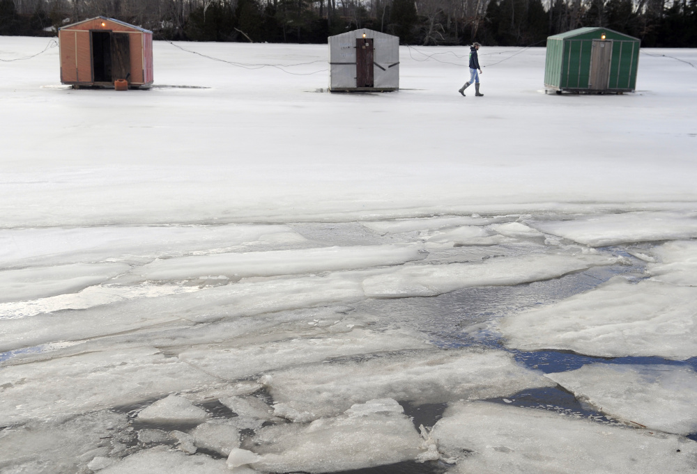 Peter James checks the smelt shacks Sunday on the Eastern River in Dresden his family maintains. Anglers have been successful fishing on the tides at James Eddy, he said, but the mild conditions and weak ice has curtailed the season.