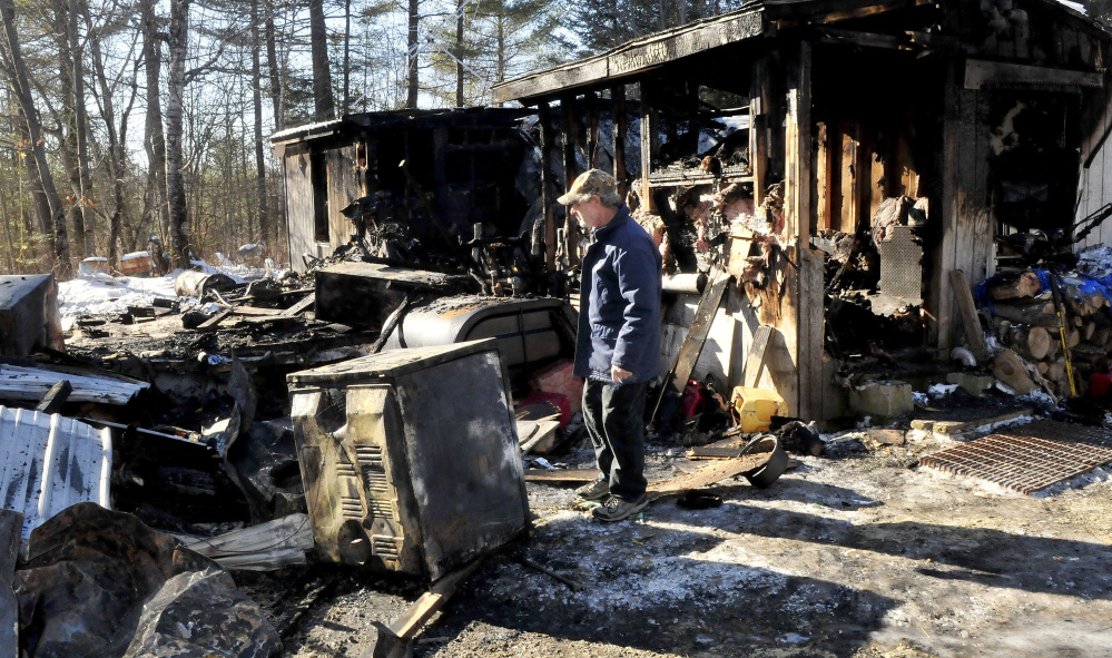 Maurice Bowring on Jan. 25 looks over the dryer that investigators determined was the source of fire that destroyed his home in Norridgewock the previous week.