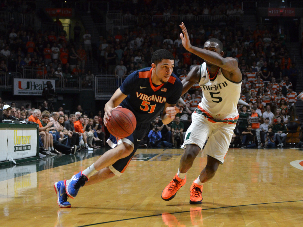 AP photo 
 Virginia's Darius Thompson attempts to get by Miami guard Davon Reed during the second half of a game Monday in Coral Gables, Florida.