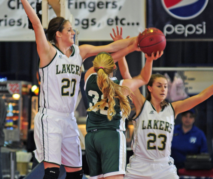 Temple Academy’s Olivia Baker, right, tries to shoot under defensive pressure from Rangleley’s Blayke Morin (20) during a Class D South semifinal game last Thursday at Augusta Civic Center.